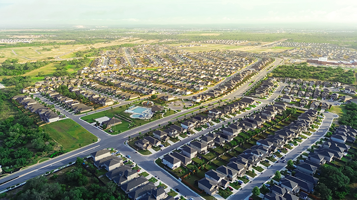 Aerial view of large master-planned HOA gated community with controlled access system